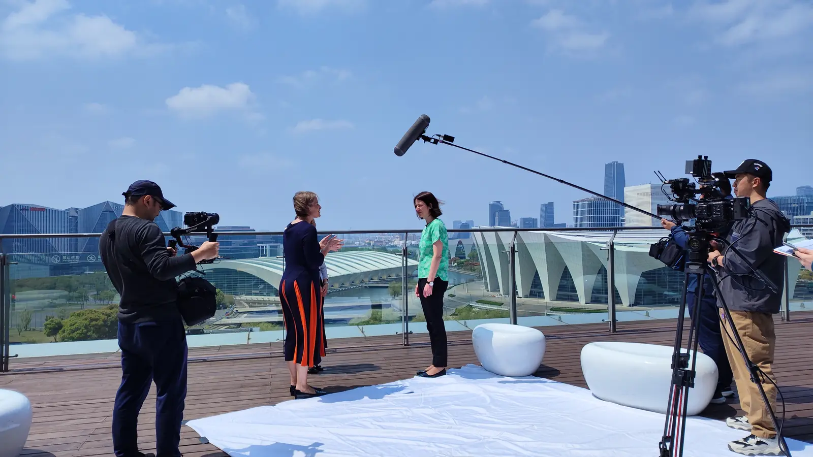 Camera crew filming an interview at an outdoor China location